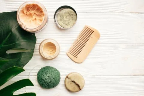 Zero waste flat lay. Natural solid shampoo bar, wooden brush,  deodorant crea 库存照片