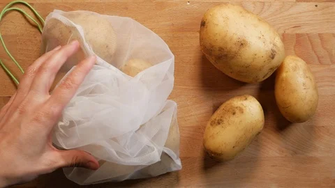 Zero waste lifestyle concept. pull on reusable bag full of potatoes Stock Footage 107220947