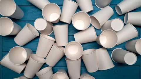 ZERO WASTE: Many paper cups on a blue table, Top view, Stop motion Stock Footage 155365343