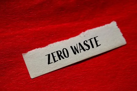 Zero waste message written on torn paper with red background. Conceptual zero Foto stock