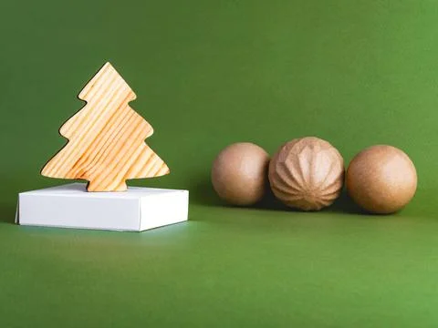 The zero waste new year concept as a wooden fir tree on the green background. Stock Photos