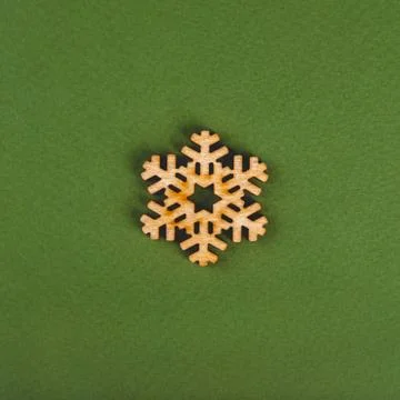 The zero waste new year concept as the wooden snowflake on the green background. Stock Photos