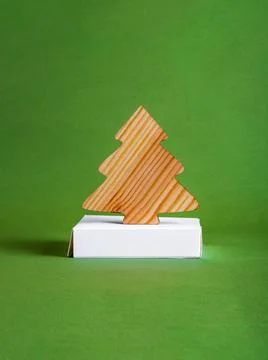 The zero waste new year concept as a wooden fir tree on the green background. Stock Photos