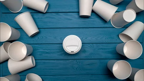 ZERO WASTE: One reusable mug and a many paper cups on a blue table, Top view Vídeo Stock 155365300