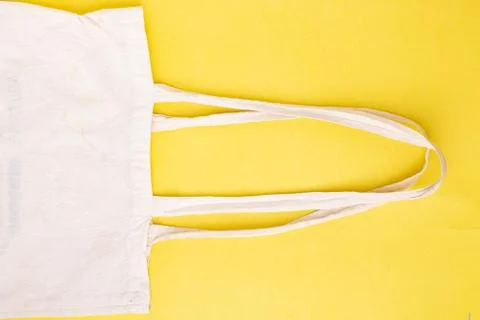 Zero waste, textile white bag on yellow paper. Stock Photos