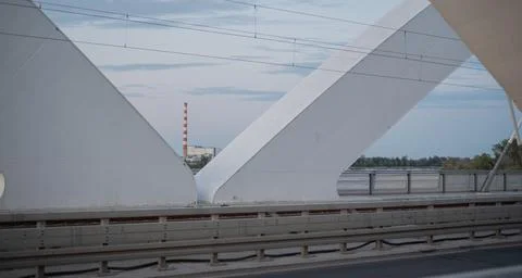 Zezelj Bridge framing industrial complex, railway tracks, cloudy sky Stock Photos