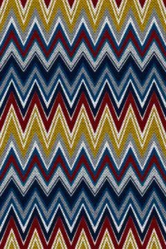 Zig-zag chevron knitted stripes in yellow, red, and blue. Seamless pattern. Stock Illustration