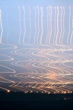 Zig Zag orange light trails in the sky Stock Photos