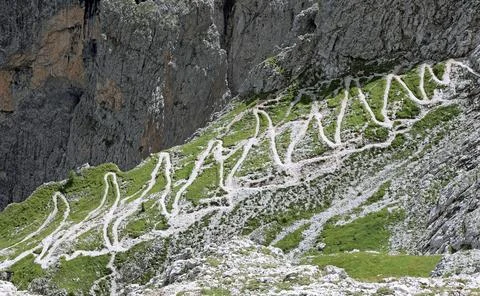 Zig zag path climbing up the steep mountain slope Stock Photos