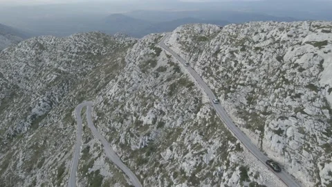 Zigzag alpine road in the rocky mountains. Curvy serpentine roads Stock Footage 214769053