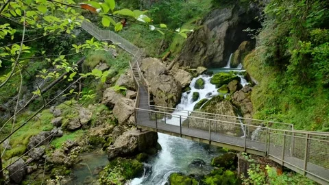 A zigzag path above a slow motion water stream. 4K Stock Footage 271653827