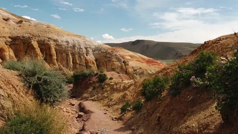 Zigzag road in a mountain gorge. Red surface of the earth. Stock Footage 167990037