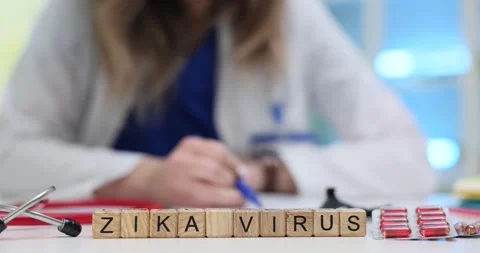 Zika Virus on cubes on desk with blister packs and doctor writing Stock Footage 314110220