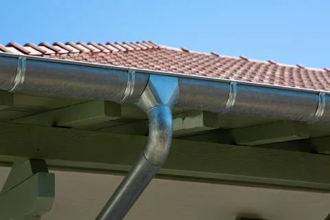 Zinc gutter silver and pipe house construction new gray metal tile roof with  Stock Photos