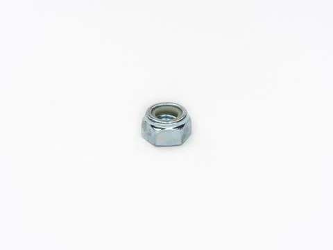 Zinc plated self locking hexagonal metric stop nut on white. Stock Photos