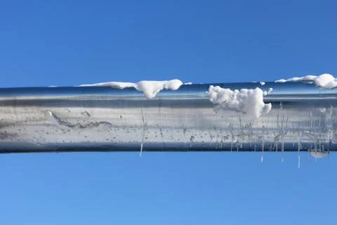 Zinced pipe shining in the winter sun Foto stock