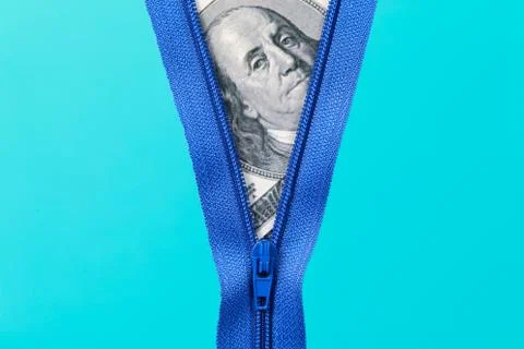 Zip with bank notes on blue background Stock Photos