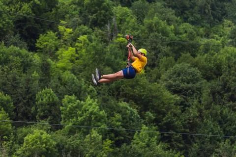 Zip line adventure, extreme rest, downhill on a rope at an angle Stock Photos