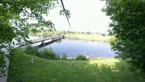 Zip line (Flying fox) adventure over water in Natural Park Comana, Romania Stock Footage 87903222