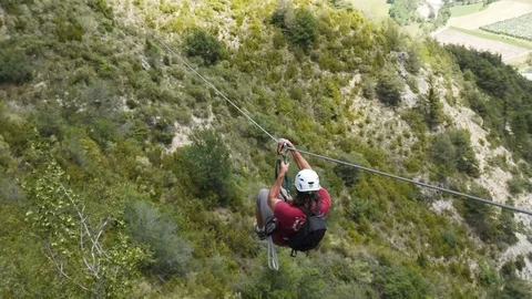 Zip line in mountains, a cable between rocks. Moving with zipline at via ferrata Video stock 126494444