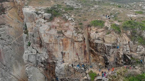 Zip-lining and rock climbing at Sea Gully, Tung Lung. Hong Kong rock climbing. Stock Footage 108523302