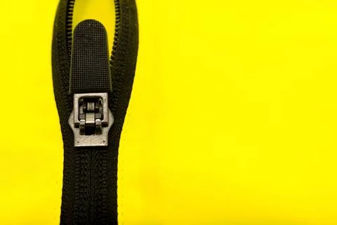 Zip lock on yellow clothes. Jacket clasp. Zipper Stock Photos