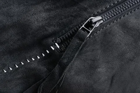 Zip with a tab on a black suede jacket with white contrasting seams Stock Photos