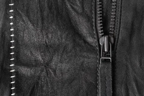 Zip with a tab on a black suede jacket with white contrasting seams Stock Photos
