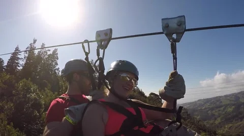 Ziplining couple in mountains Stock Footage 63502501