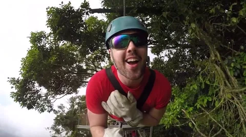 Ziplining guy having time of his life Stock Footage 63502517