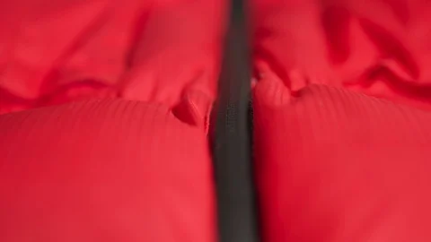 Zipper on a down jacket. putting on a red jacket Stock-Footage 121312045