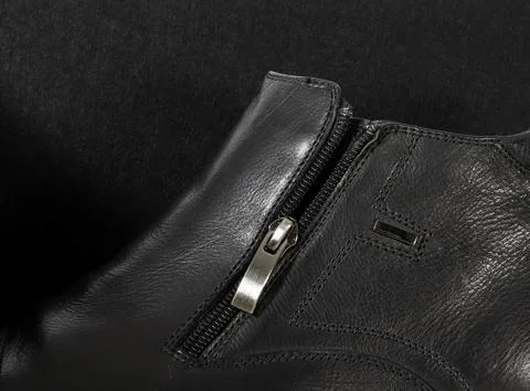 Zipper of a man's boot in a low key. Stock Photos