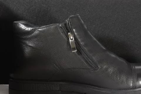Zipper of a man's boot in a low key. Stock Photos