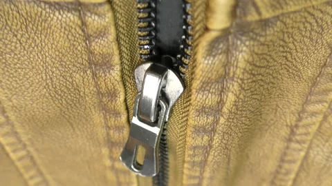 The zipper opens on the brown leather jacket. Stock Footage 140170523