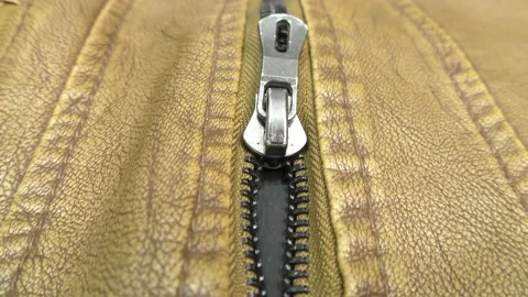 The zipper opens on the brown leather jacket. Stock Footage 140170630