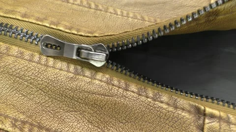 The zipper opens on the brown leather jacket. Stock Footage 140170741