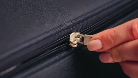 Zipper on suitcase close up, fingers pull at the zipper tab. Packing bags Stock Footage 319005292