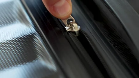 Zipper on suitcase, close-up. Hands open zipper of a black travel luggage. Stock Footage 272436782