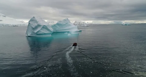 Zodiac approaching iceberg Stock Footage 99804226