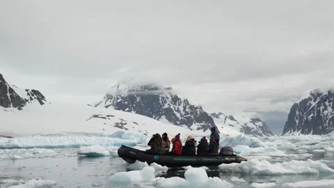 Zodiac Boat Navigates Through Floating Ice Floes In Antarctica Under Cloudy Sky Stock Footage 339096664