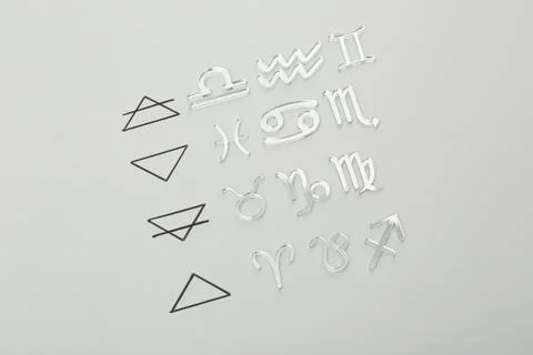 Zodiac triplicity. Four elements and corresponding signs on grey background.. 스톡 사진