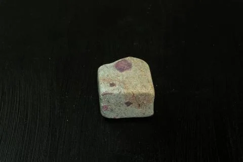 Zoisite, saualpite or ruby in the host rock. Natural mineral stone on a black 写真素材