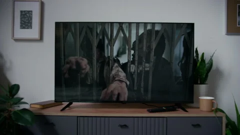 Zombie Attack Movie Playing on Flat-Screen TV in Living Room Stock Footage 293764053