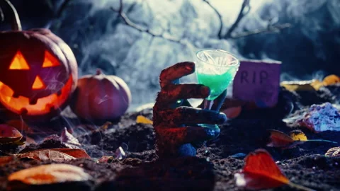 Zombie hand rises glass alcoholic drink. Perfect footage scary halloween party. Stock Footage 253997781