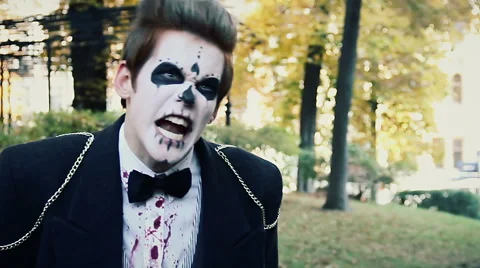 Zombie invasion in city, crazy monster threatening to bite victim, showing teeth Stock Footage 59082932