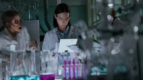 Zombie Lab Technicians Attacking Scientist Working Alone at Night Stock Footage 293784973