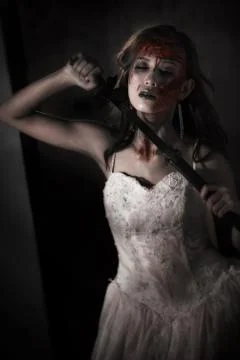 Zombie lady corpse holding sword to kill herself while wedding. Horror and Gh 写真素材
