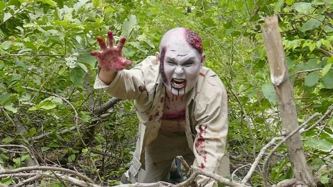 Zombie monster crawls on the ground in forest,slow motion. Stock Footage 95459979