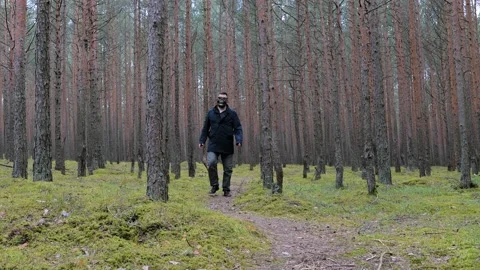 Zombie in scary skeleton mask walking in forest. Stock Footage 154476367