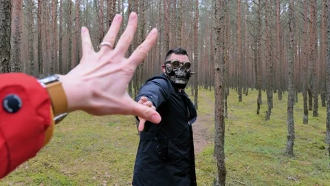Zombie in scary skeleton mask walking in forest. Stock Footage 154476641